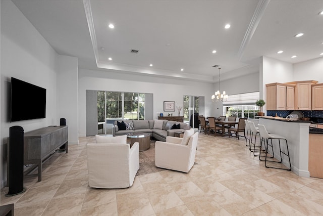 9637 Spray Dr, West Palm Beach, FL 33411 - living room featuring recessed lighting, a chandelier, a raised ceiling, and a high ceiling