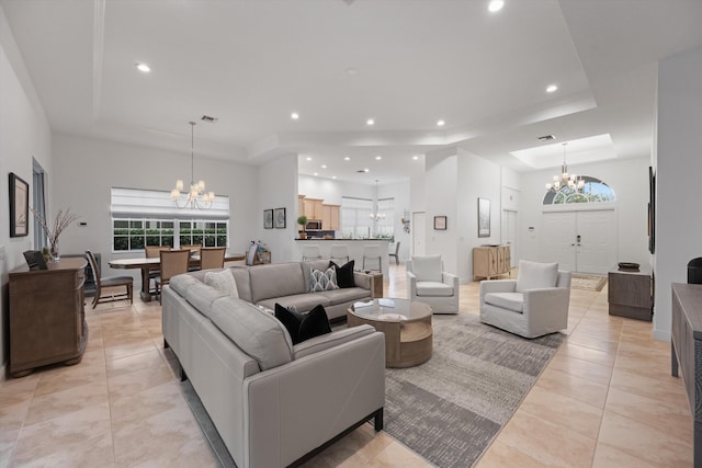 9637 Spray Dr, West Palm Beach, FL 33411 - living area with a chandelier, a tray ceiling, light tile patterned flooring, and recessed lighting