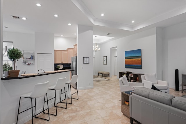 9637 Spray Dr, West Palm Beach, FL 33411 - living room featuring a chandelier, recessed lighting, ornamental molding, and a tray ceiling