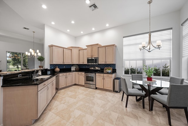 9637 Spray Dr, West Palm Beach, FL 33411 - kitchen featuring appliances with stainless steel finishes, a chandelier, light brown cabinetry, a high ceiling, and decorative backsplash