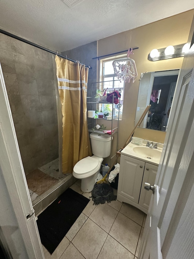 full bath with toilet, a stall shower, tile patterned floors, a textured ceiling, and vanity