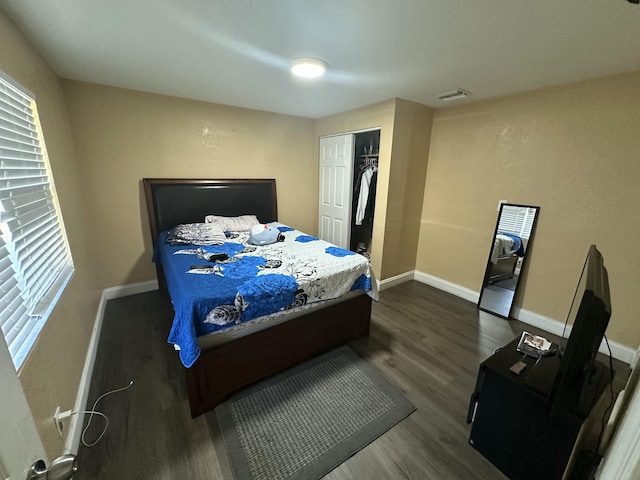 bedroom with visible vents, baseboards, and dark wood-style floors