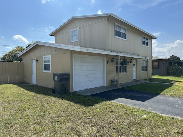 exterior space with aphalt driveway, an attached garage, a lawn, and fence