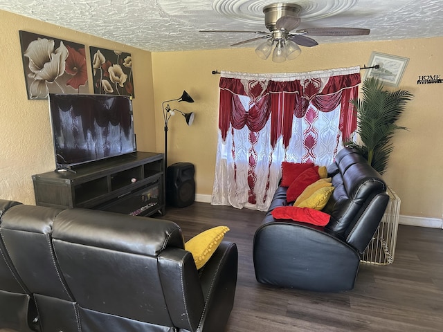 living room featuring baseboards, wood finished floors, and ceiling fan