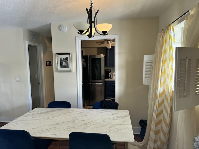 148 Yacht Club Dr Unit 13, North Palm Beach, FL 33408 - dining space with baseboards, visible vents, a textured ceiling, and ceiling fan