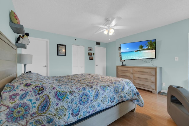 7240 Huntington Ln Unit 802, Delray Beach, FL 33446 - bedroom with wood finished floors, a textured ceiling, baseboards, visible vents, and ceiling fan