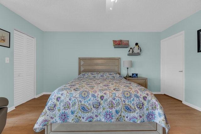 7240 Huntington Ln Unit 802, Delray Beach, FL 33446 - bedroom featuring baseboards, a closet, and wood finished floors