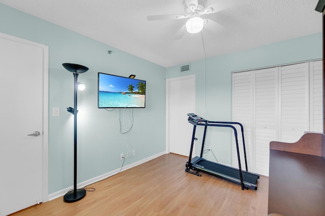 7240 Huntington Ln Unit 802, Delray Beach, FL 33446 - workout room with a ceiling fan, wood finished floors, a textured ceiling, baseboards, and visible vents