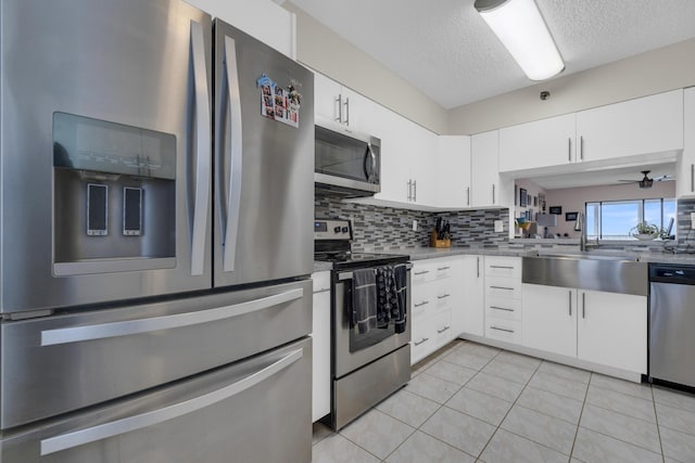 7240 Huntington Ln Unit 802, Delray Beach, FL 33446 - kitchen with light tile patterned floors, a sink, stainless steel appliances, and tasteful backsplash