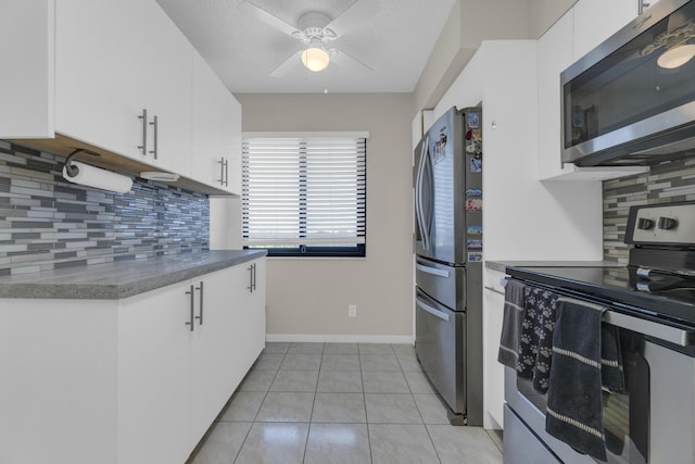 7240 Huntington Ln Unit 802, Delray Beach, FL 33446 - kitchen with white cabinetry, light tile patterned floors, stainless steel appliances, and ceiling fan