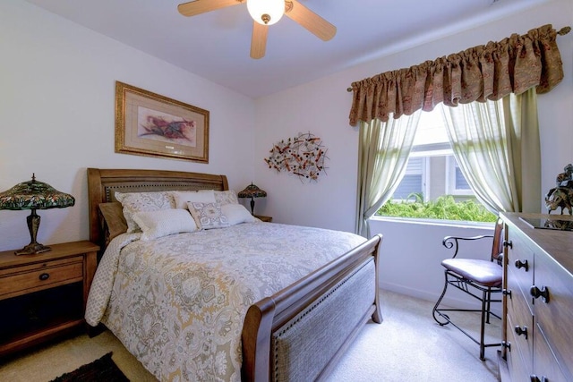 bedroom featuring light colored carpet and ceiling fan