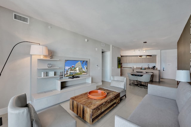 living area with light tile patterned floors and visible vents