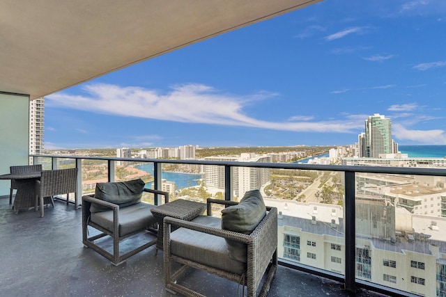 balcony featuring a view of city and a water view