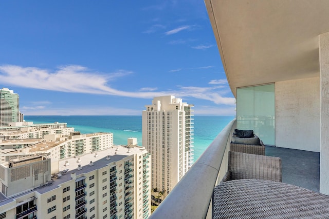 balcony featuring a city view and a water view