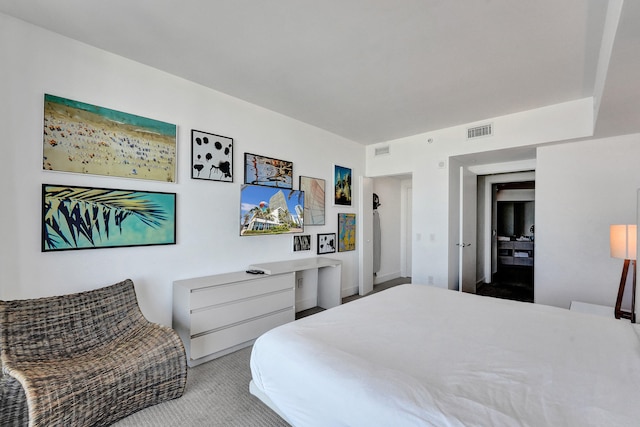 bedroom with visible vents and light colored carpet