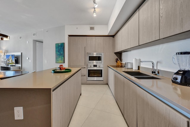 kitchen featuring light tile patterned floors, visible vents, a sink, stainless steel appliances, and light countertops