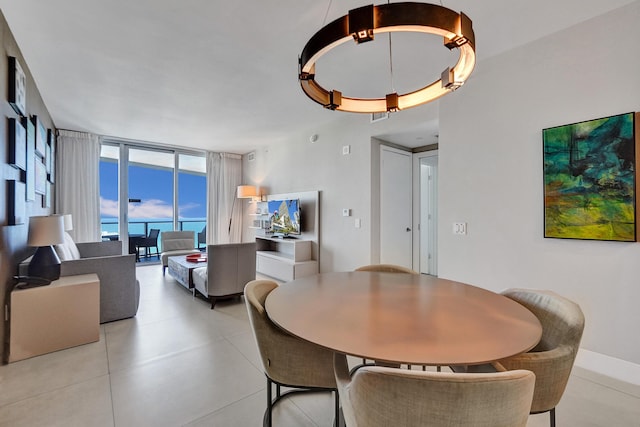 dining space with light tile patterned flooring and expansive windows