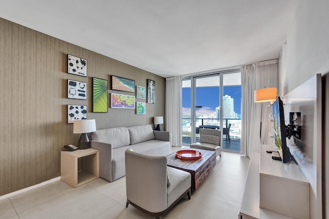 living room with a wall of windows and light tile patterned floors