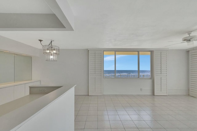 empty room featuring light tile patterned flooring and a ceiling fan