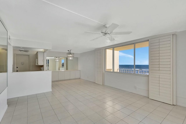 unfurnished living room featuring light tile patterned floors and a ceiling fan