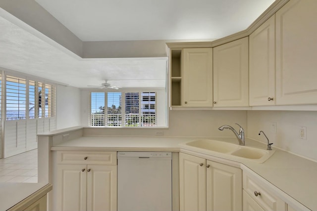 kitchen with a peninsula, white dishwasher, ceiling fan, a sink, and light countertops