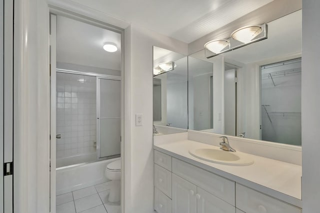 full bath featuring tile patterned floors, enclosed tub / shower combo, toilet, and vanity