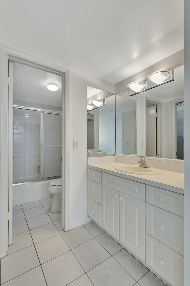 bathroom with tile patterned floors, toilet, vanity, and shower / bath combination