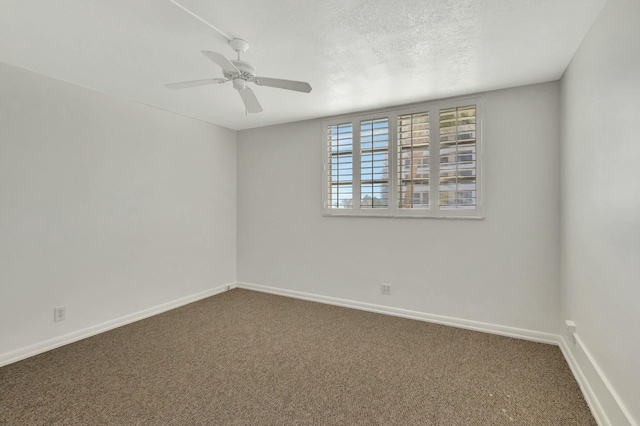 carpeted spare room featuring ceiling fan, baseboards, and a textured ceiling