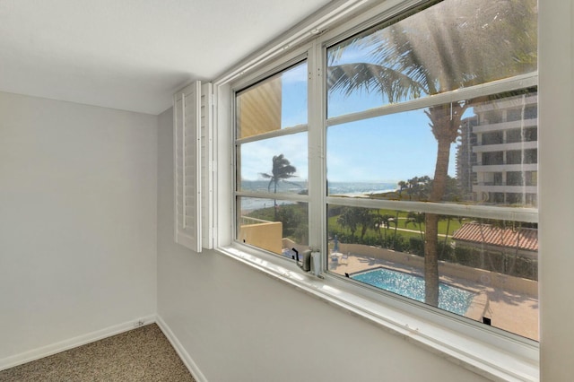 empty room with carpet flooring and baseboards