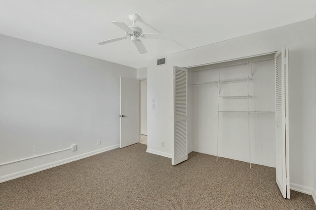 unfurnished bedroom with visible vents, carpet, a closet, and a ceiling fan