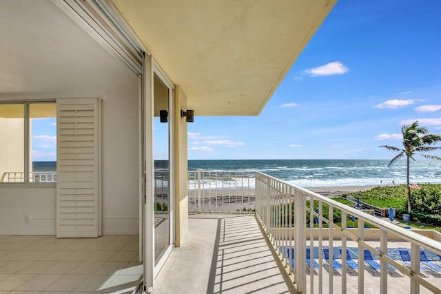 balcony with a beach view and a water view