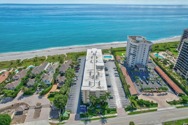 birds eye view of property featuring a view of the beach and a water view