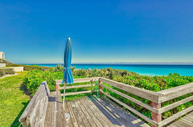 view of community featuring a beach view and a water view