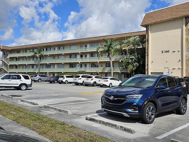 view of building exterior with uncovered parking