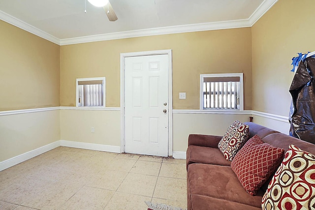 interior space featuring baseboards, ceiling fan, and crown molding