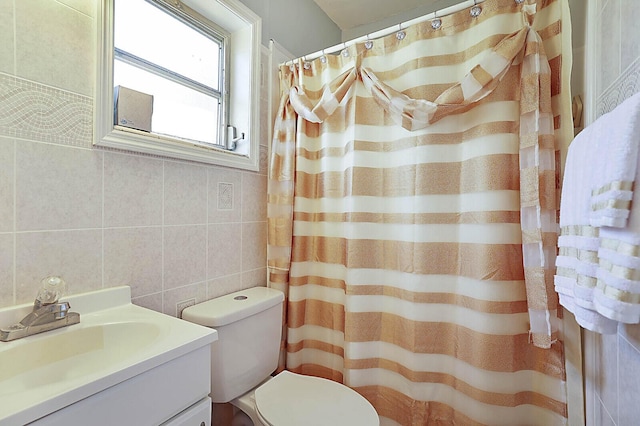 bathroom with vanity, tile walls, curtained shower, and toilet