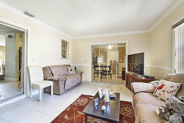 living area with tile patterned flooring, visible vents, and ornamental molding