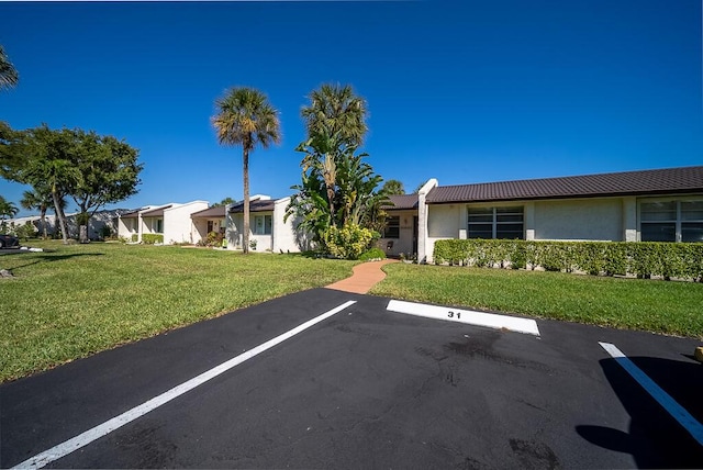 uncovered parking lot featuring a residential view