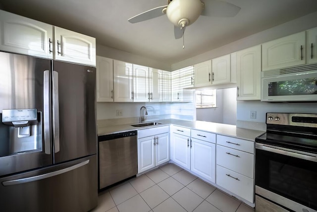 kitchen with a ceiling fan, a sink, appliances with stainless steel finishes, white cabinets, and light countertops