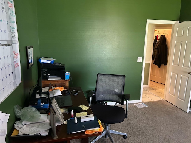 carpeted office featuring tile patterned flooring and baseboards