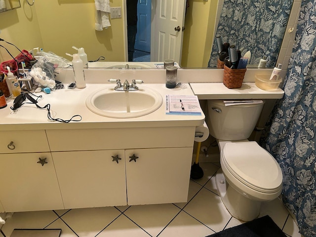 bathroom featuring tile patterned floors, toilet, and vanity