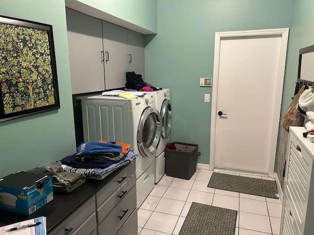 washroom with light tile patterned floors, cabinet space, and separate washer and dryer