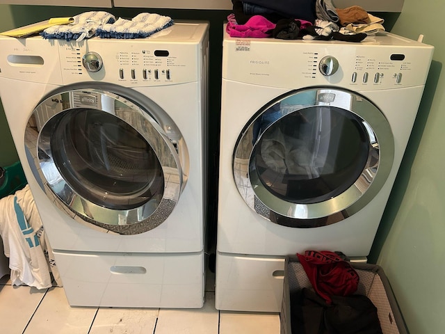 washroom with tile patterned floors, laundry area, and separate washer and dryer