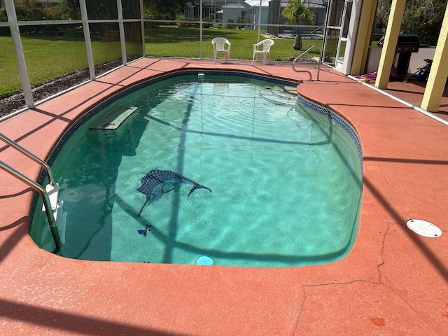 pool with glass enclosure, a patio area, a lawn, and a grill