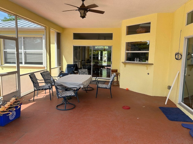 sunroom / solarium featuring ceiling fan