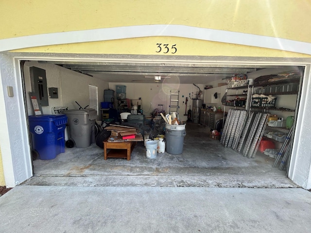 garage with gas water heater and electric panel