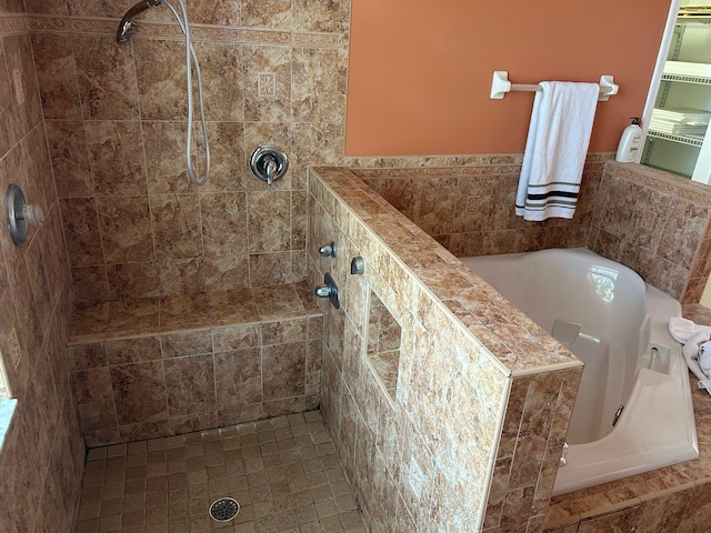 bathroom featuring tiled shower and a garden tub