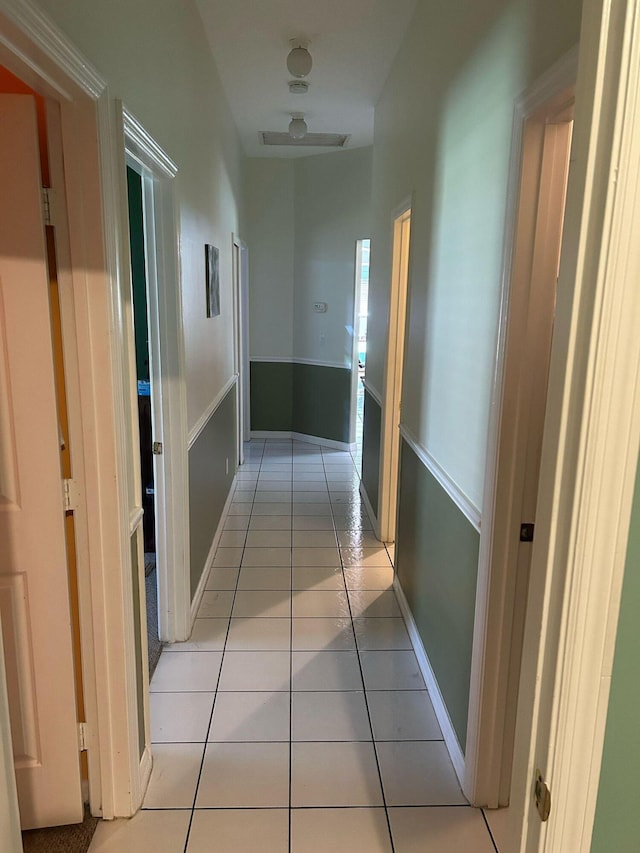 hall with light tile patterned floors and baseboards