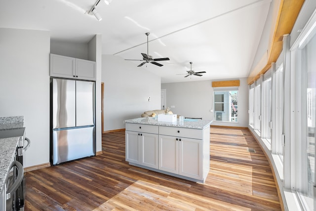 kitchen featuring ceiling fan, freestanding refrigerator, lofted ceiling, and wood finished floors