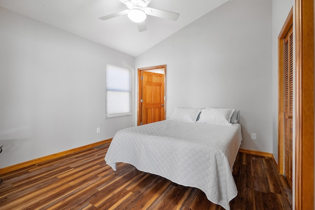 bedroom with lofted ceiling, wood finished floors, baseboards, and ceiling fan